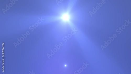 A clear, sunny day with bright sunlight illuminating a deep blue sky. The sun is high with a radiant flare