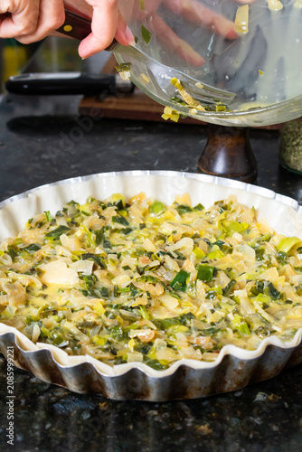 Young Chef Filling Pie Crust with Fresh Vegetable Mix