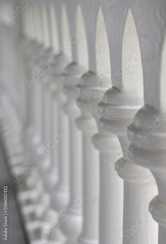 Bild auf Leinwand Elegant white balustrade with repeating arches and columns in selective focus