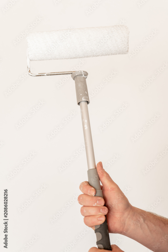 Obraz premium Room renovations. White paint for walls. Hand Painting Wall With Roller 