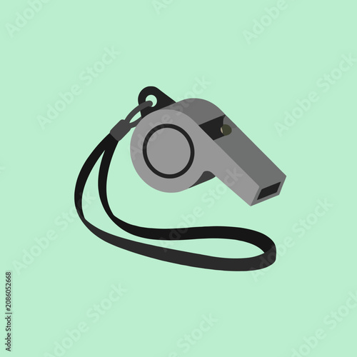 Grey athletic whistle with a black strap on a green background