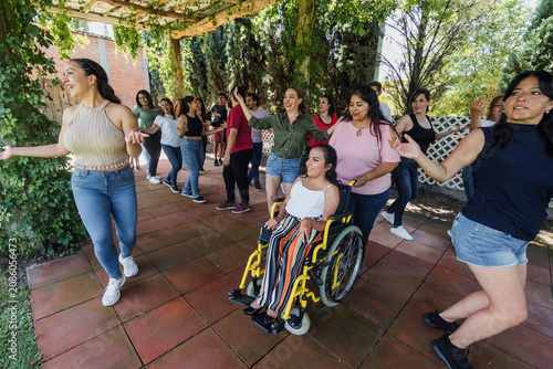 Group of latino friends enjoying a salsa dancing class outdoors in Mexico Latin America. Hispanic people moving to the rhythm and having a fun together