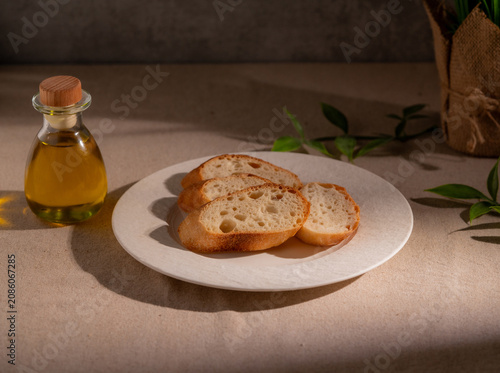 Rustic Sliced Artisan Bread with Olive Oil on White Plate, Cozy Food Photography