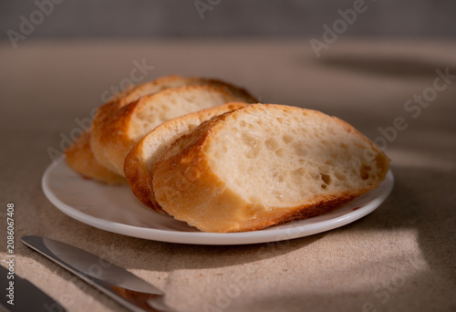 Rustic Sliced Artisan Bread with Olive Oil on White Plate, Cozy Food Photography