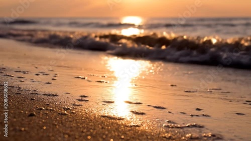 Close-up of sparkling wet sand and ocean foam.