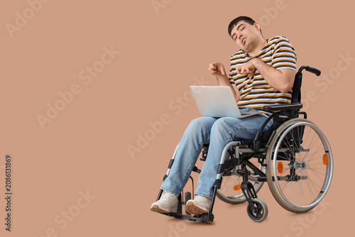 Young man in wheelchair wit...
