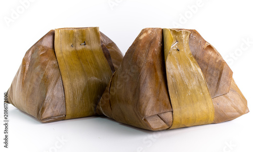 Two Pieces of Traditional Indonesian Steamed Kue Bugis Wrapped in Banana Leaf