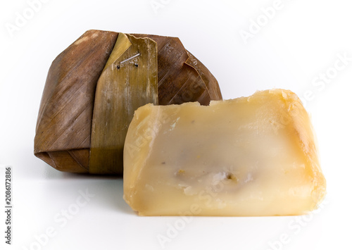Traditional Indonesian Kue Bugis Wrapped in Banana Leaf with One Slice