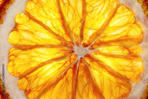 Bild auf Leinwand Bright and juicy round orange slice in macro detail