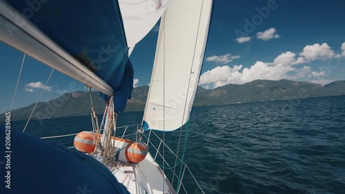 Sailing boat moves under the sails in the fresh sea. Sailing vessel details, no people