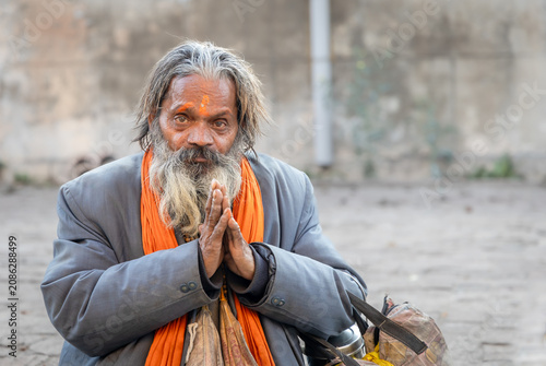 Obraz na płótnie Candid Portrait of Bearded Hindu Monk Wearing Traditional Religious Clothing
