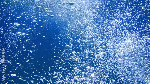 Ocean blue underwater with sunrays, Underwater Sea Deep Water Abstract Sunshine, sea wave , clean waters in summer time, Natural underwater seascape, sand on ocean floor and water surface sunlight.