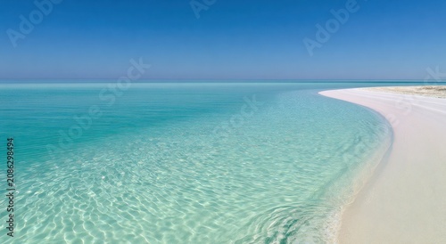 Tropical sandbank beach with curved coastline crystal clear turquoise sea. Exotic island paradise perfect summer vacation