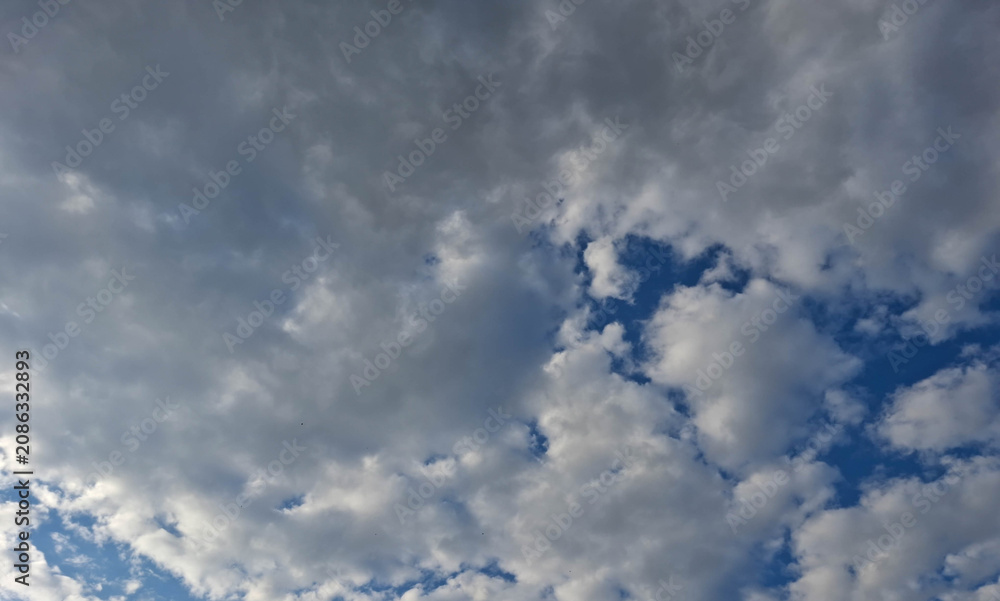 Fototapeta premium Dramatic cloud layers with glimpses of intense blue sky