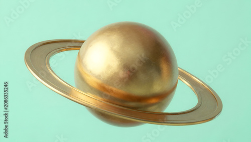 Minimalist Golden Planet Saturn Model over Mint Green Background