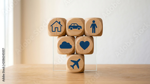 Stacking wooden blocks with blue icons on a table in a minimalist studio setting