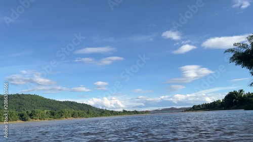 Peaceful Mekong River Landscape with Green Leaves and Blue Sky in Northern Thailand
