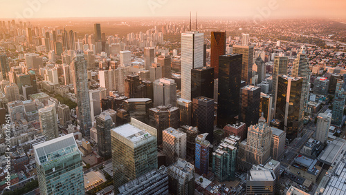 Aerial view of a sprawling city skyline at sunset, modern skyscrapers, urban landscape