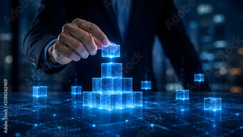 Digital business architecture and tech foundation concept with a hand building a glowing blue holographic cube pyramid