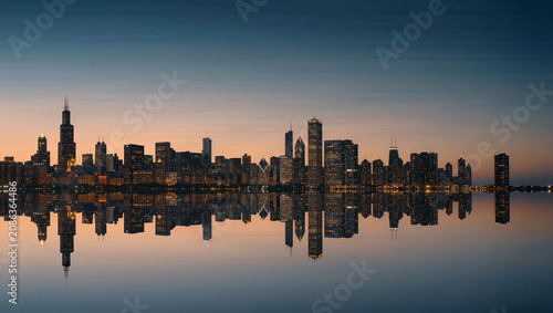 Chicagoland skyline panorama with water reflection at dusk