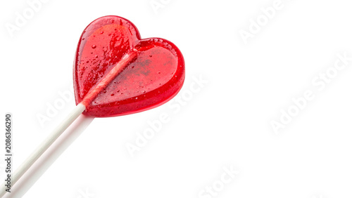Konstfotografi Bright red heart shaped glossy lollipop candy on a stick isolated on transparent