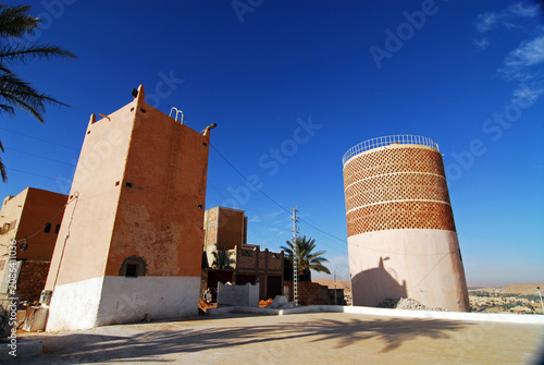 Algeria, Melika, low angle view of water tower by buildings against blue sky