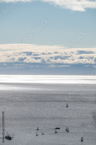 Sailing boats on the sparkling Seto Inland Sea with distant mountains