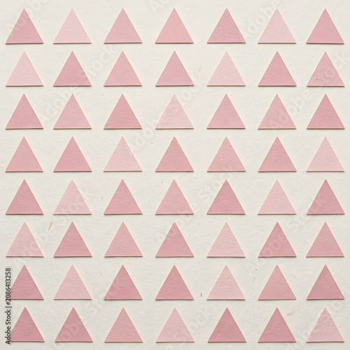 Geometric pattern of pink and white triangles on grid.