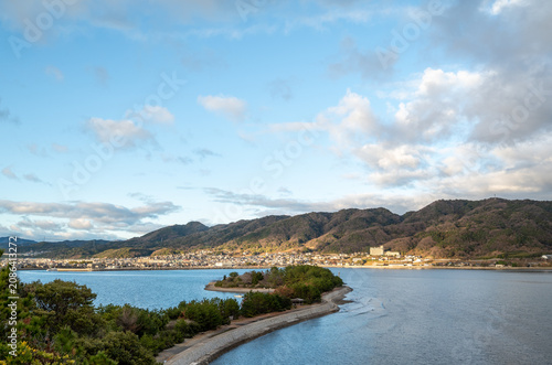 Panoramic landscape of the Seto Inland Sea with a coastal village and mountains