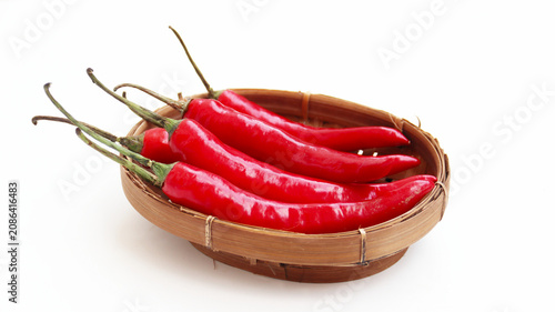 Tableau sur toile red hot chili pepper on wicker bamboo bowl isolated on white