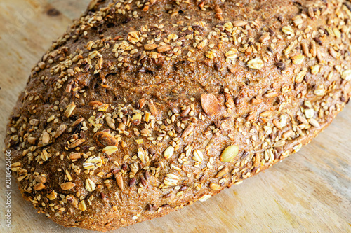 Konstfotografi Extreme close up of the crunchy seeded crust of a multigrain bread loaf, covered with sunflower seeds, pumpkin seeds and oats, a wholesome artisan bakery texture