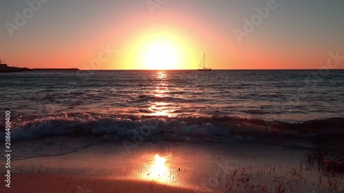 Golden Sunset Over the Sea and Beach with Orange Sky, Calm Ocean Waves, Horizon Reflection and Summer Evening Coastal Landscape