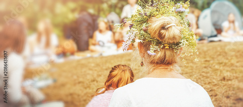 Rear view of woman wearing floral crown during summer solstice.
