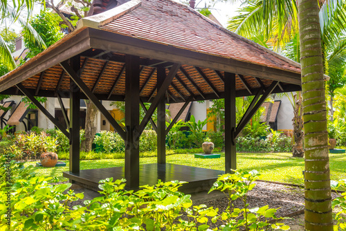 Schilderij op canvas beautiful wooden gazebo in tropical nature in Thailand