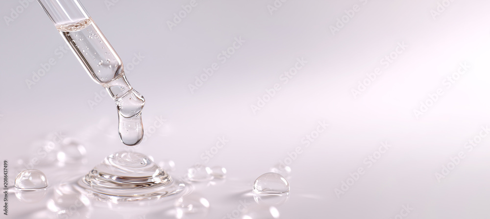 Naklejka premium glass pipette with serum drop on light background