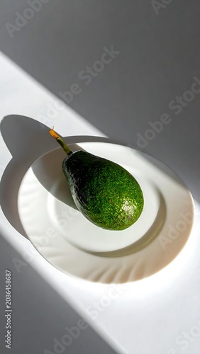 Close up of a green smoothie in a glass with straw.