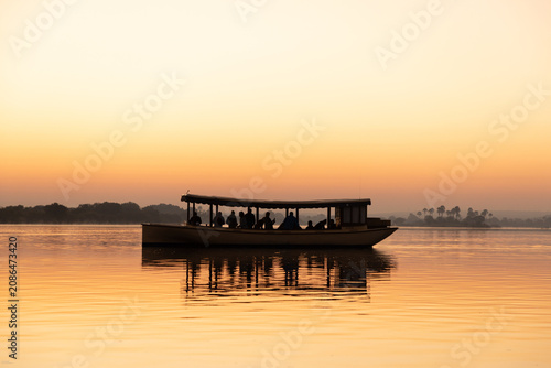 Bild auf Leinwand vintage boast on the Zambezi River at sunrise, Zimbabwe, Africa