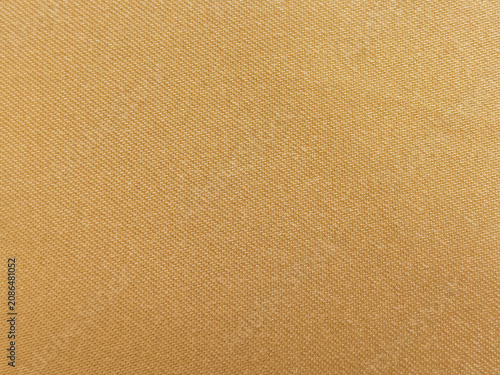 A detailed macro close-up view showing the uniform geometric weave pattern and thread texture of a gold yellow fabric sheet. Target uses for this commercial image include 3D clothing texturing maps
