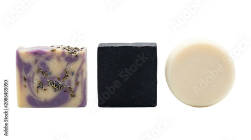 Three bars of soap in different colors and textures for hygiene and skincare isolated on a transparent background