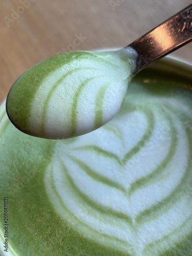 Decorated milk foam on top of Matcha latte