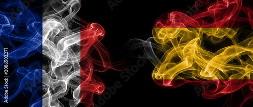 French flag smoke versus Spanish flag smoke on black background, abstract representation of national identity, diplomacy and cultural connection.