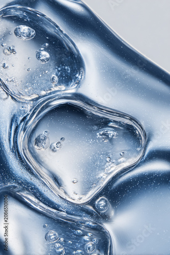 Blue transparent gel with bubbles, clear liquid texture for skincare and beauty product concept