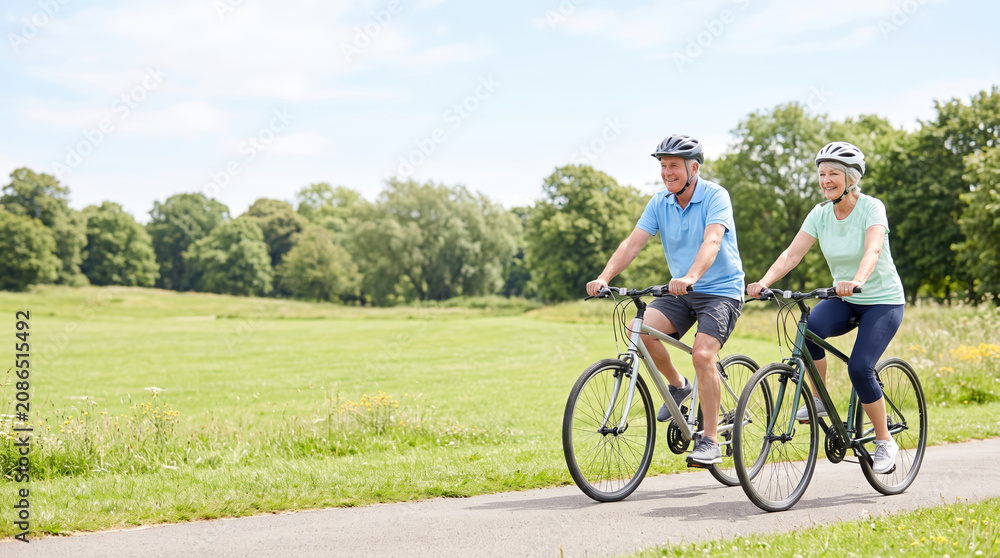 Fototapeta premium Active couple enjoying a bike ride together outdoors