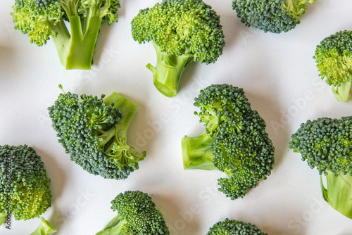 Seamless Fresh broccoli florets isolated on white as food background. Full Frame fresh broccoli cuts close-up. Top view. Flat lay