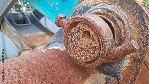 Bright turquoise painted metal with rust spots