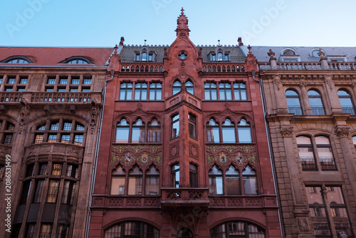Berlin, Germany: Intricate neo-gothic red brick facade of a historic building with ornate architectural details, European urban heritage landmark.