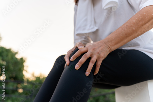 Quadro su tela Elderly woman hand massaging her leg suffering leg pain showing senior health problems with muscle pain and joint stiffness, insurance in retirement for wellbeing and quality of life