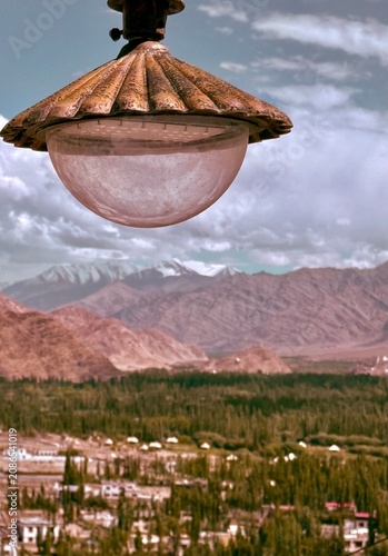 Vintage light bulb framed by barren mountain scenery