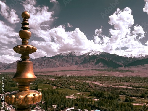 Monastic retreat framed by dry, rocky mountains.