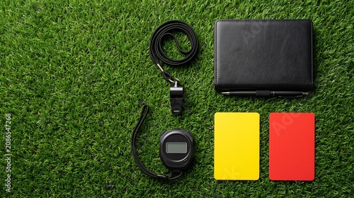 Soccer referee equipment includes cards and whistles used on the field.